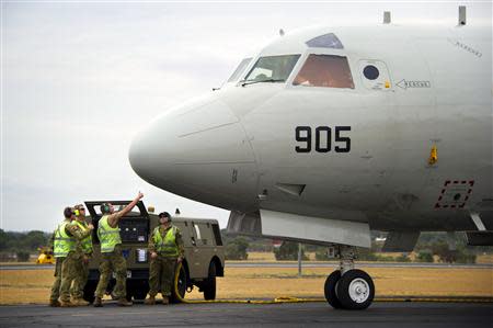 Ground staff assist a Republic of Korea Navy (ROKN) P-3C Orion maritime patrol aircraft after it arrived at the Royal Australian Air Force (RAAF) Base Pearce, located north of Perth, to participate in the search for missing Malaysia Airlines flight MH370 in the southern Indian Ocean in this picture released by the Australian Defence Force March 27, 2014. REUTERS/Australian Defence Force/Handout via Reuters