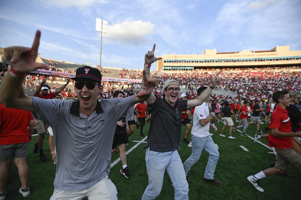 Texas Tech fans run on the field after Texas Tech won in overtime against Houston after an NCAA college football game Saturday, Sept. 10, 2022, in Lubbock, Texas. (AP Photo/Justin Rex)
