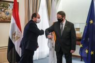 Cypru's President Nicos Anastasiades and Egypt's President Abdel Fattah al-Sisi bump their elbows before a trilateral summit between Greece, Cyprus and Egypt, at the Presidential Palace in Nicosia