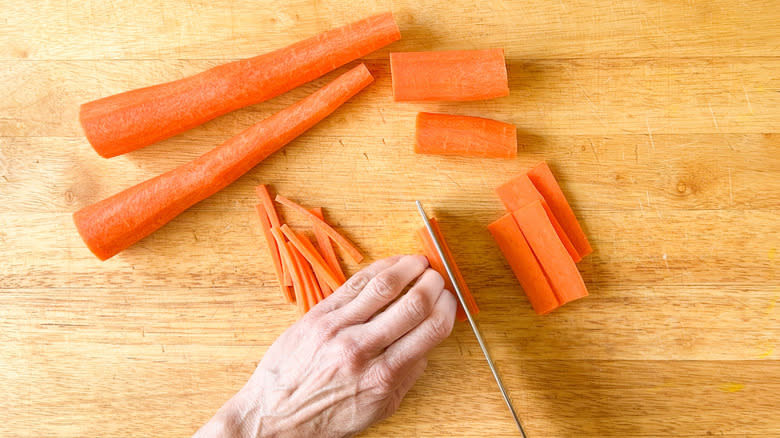 knife chopping carrots