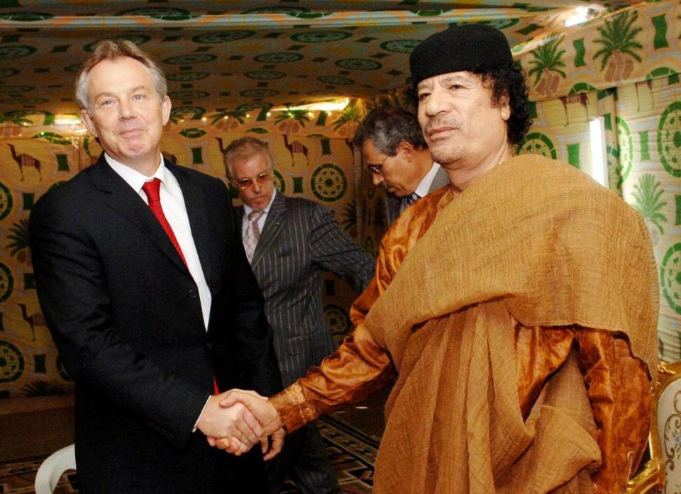 Tony Blair and Colonel Gaddafi shake hands during the 2004 ‘deal in the desert’ (PA)