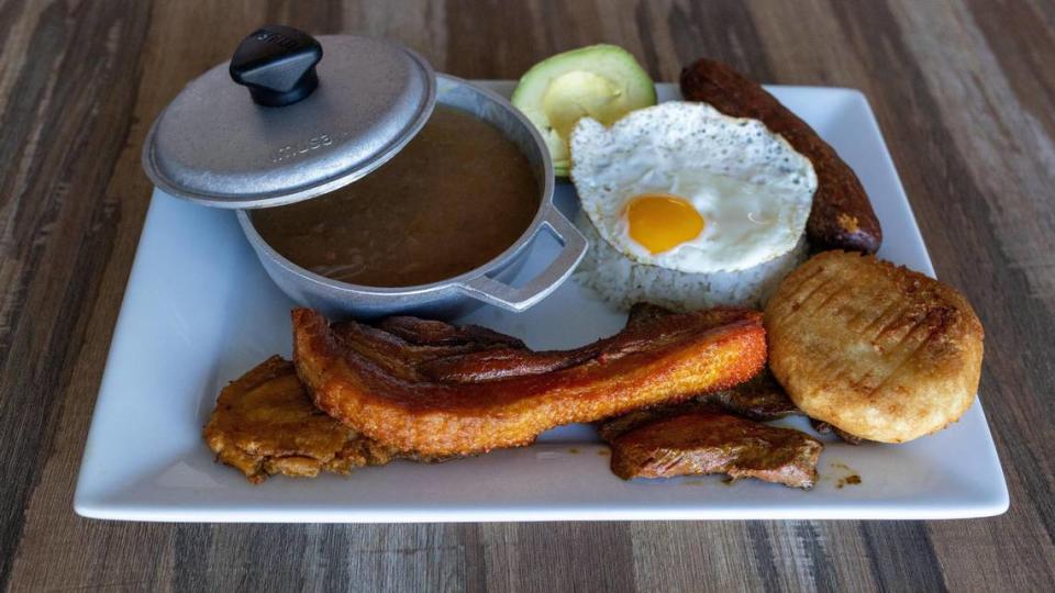 Bandeja Paisa, a traditional Colombian dish from the Andean region, features beans, rice, arepa, chorizo, plantain, avocado, beef and more.