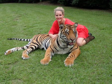 The tiger Arjuna is pictured with Moksha Bybee at Myrtle Beach Safari in Myrtle Beach, South Carolina, U.S, in this handout photo provided by MyrtleBeachSafari.com. MyrtleBeachSafari.com/Handout via Reuters