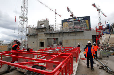 Technicians work near the circular bioshield inside the construction site of the International Thermonuclear Experimental Reactor (ITER) in Saint-Paul-lez-Durance, southern France, April 13, 2018. REUTERS/Jean-Paul Pelissier