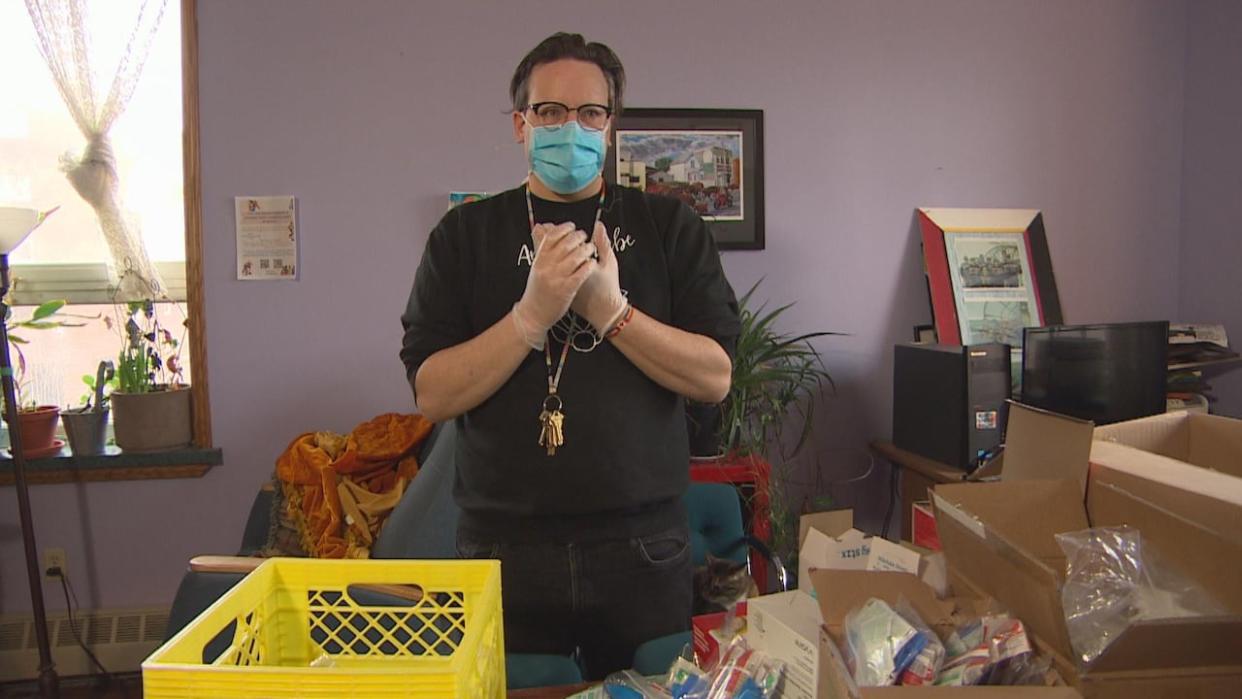 Levi Foy, executive director of Sunshine House, is seen putting together harm reduction kits. The community drop-in and resource centre has been operating Manitoba's only mobile overdose prevention site out of an RV since Oct. 2022. (CBC - image credit)