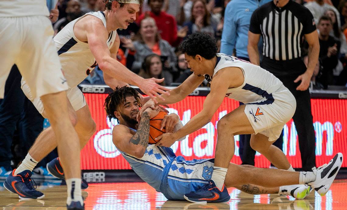 North Carolina’s R.J. Davis (4) is trapped by Virginia’s Ben Vander Plas (5) and Kihei Clark (0) in the second half on Tuesday, January 10, 2023 at John Paul Jones Arena in Charlottesville, Va.