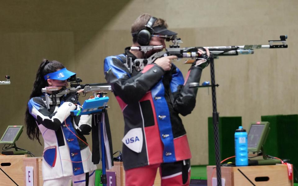 Mary Carolynn Tucker, left, and Lucas Kozeniesky won a silver medal in the 10 meter air rifle mixed team event in Tokyo