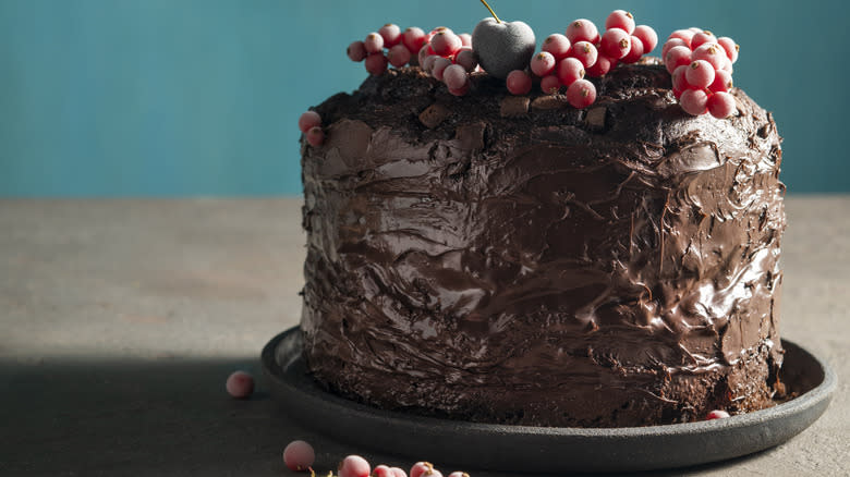 tall chocolate cake wih berries