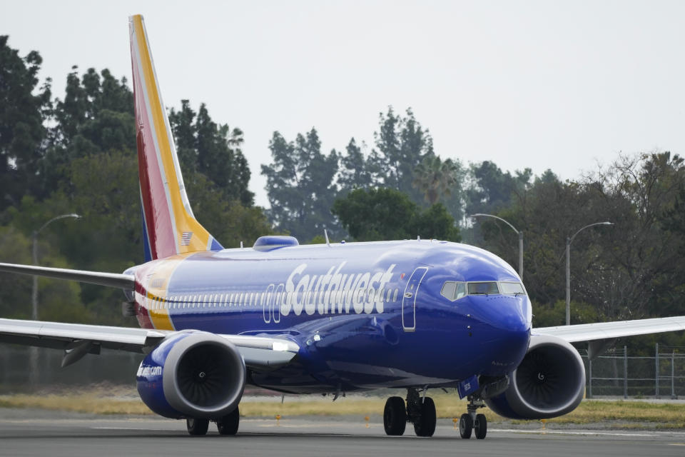 A Southwest Airlines plane taxis on the runway at Long Beach Airport, Tuesday, April 18, 2023, in Long Beach, Calif. Southwest Airlines says planes are taking off again Tuesday after departures were held up because of what the airline calls an intermittent technical problem. (AP Photo/Ashley Landis)