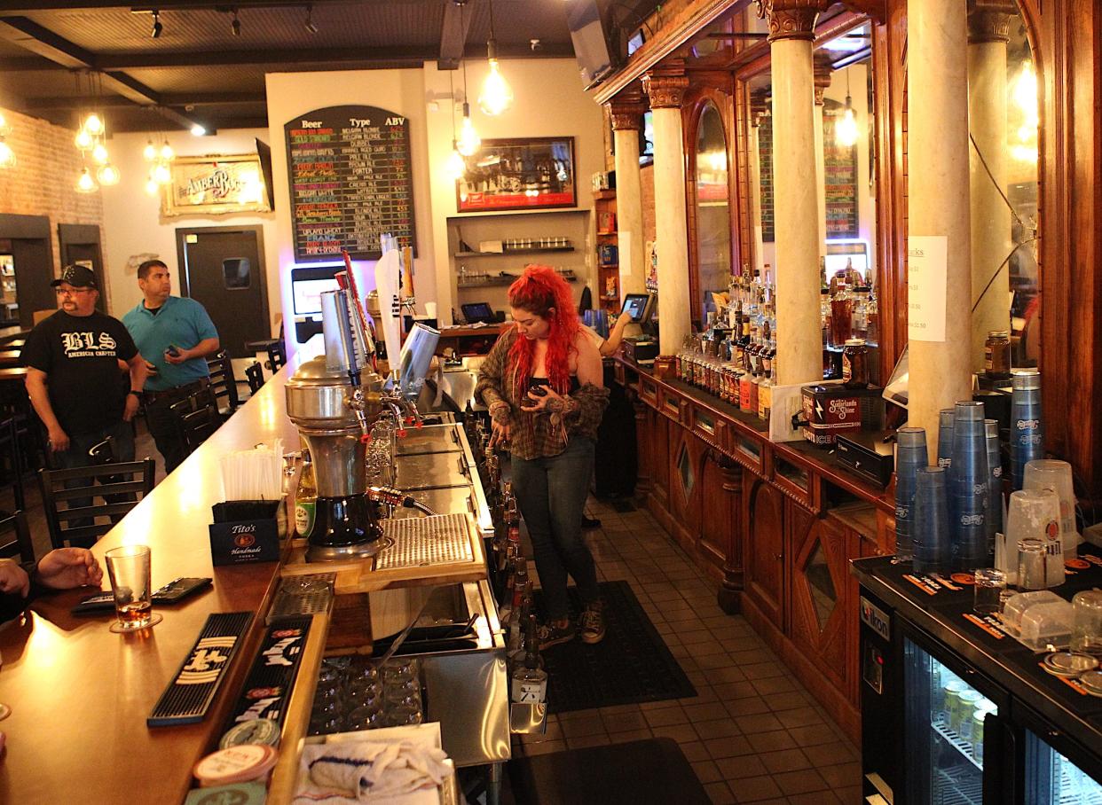 Downtown at Dacar's Manager Brittany Magnuson works behind the bar. The downtown bar reopened  in November after an extensive renovation by owner Mark Magnuson.