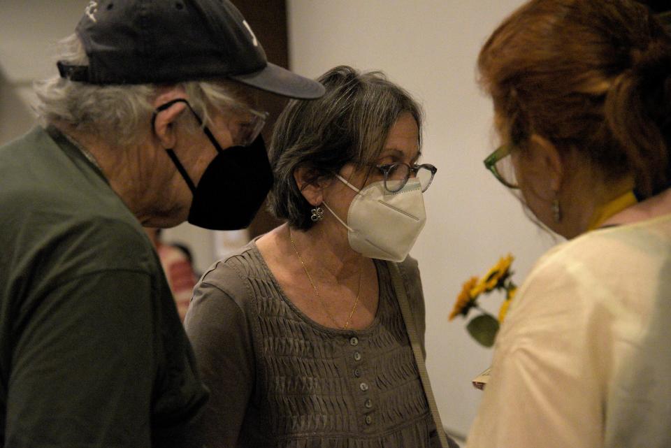 Steve and Ina Kichen, left, buy sunflower pins from Nathalie Halbout during an Orthodox Easter Fundraiser on Friday, April 14, 2023 at the Unitarian Universalist meeting house in Middletown, New Jersey. Steve Kichen tutors Nathalie Halbout’s niece Maiia Dvokina English, although he jokes that her English is better than his. 