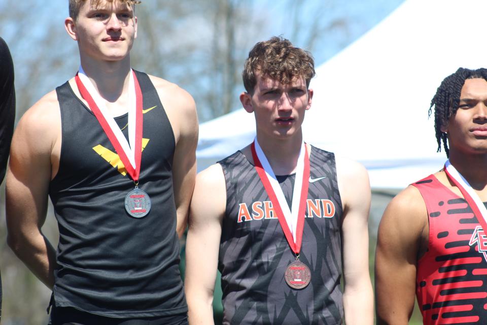 Ashland's Braydon Martin stands on the podium with his medal after finishing fourth in the 110 hurdles final.