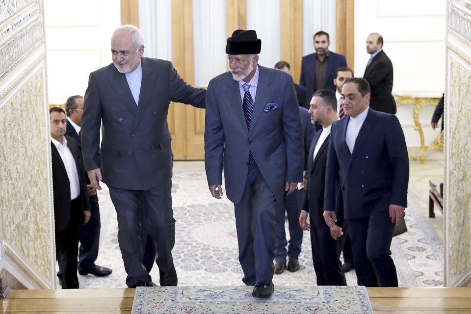 Iranian Foreign Minister Mohammad Javad Zarif, left, welcomes his Omani counterpart Yousuf bin Alawi for their meeting, in Tehran, Iran, Saturday, July 27, 2019. (AP Photo/Ebrahim Noroozi)