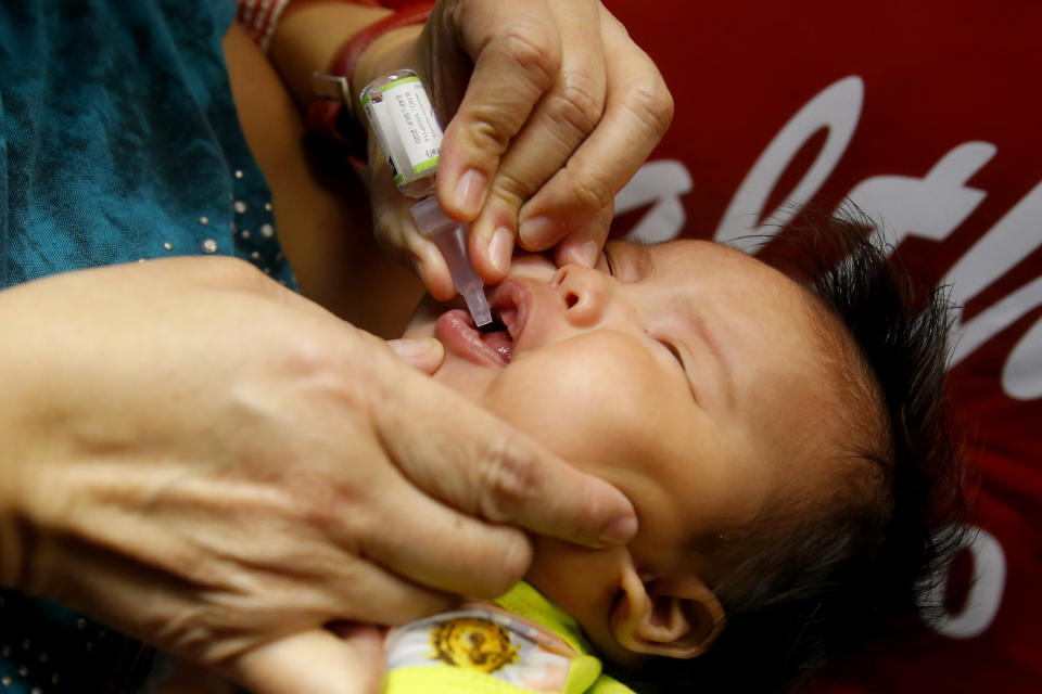 FILE- In this Sept. 20, 2019 photo, a baby gets an oral anti-polio vaccine during the launch of a campaign to end the resurgence of polio after health authorities confirmed a polio case in the country in Quezon city, Philippines. A polio outbreak in the Philippines has ended, according to the World Health Organization and the United Nations Children's Fund, Friday June 11, 2021 which praised government efforts to fight the disease despite the coronavirus pandemic. (AP Photo/Bullit Marquez)