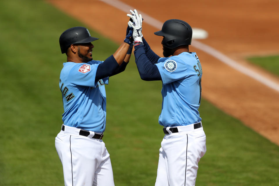 PEORIA, AZ - FEBRUARY 25: Domingo Santana #16 of the Seattle Mariners celebrates with Edwin Encarnacion #10 after hitting a home run during a Spring Training game against the Cincinnati Reds on Monday, February 25, 2019 at Peoria Sports Complex in Peoria, Arizona.  (Photo by Alex Trautwig/MLB Photos via Getty Images) 