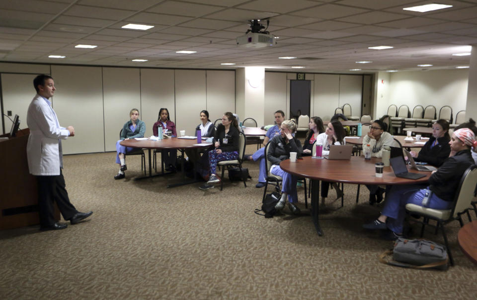 Dr. Keith Reisinger-Kindle, associate director of the OB-GYN residency program at Wright State University's medical school in Dayton, Ohio, leads a lecture of OB-GYN residents in the Wright State program Wednesday, April 13, 2022. The physician created and implemented abortion coursework for medical students and residents, with support from his university, and offers training at a nearby clinic where he also performs abortions. (AP Photo/Paul Vernon)