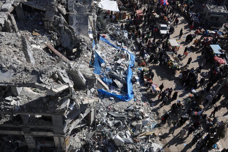 An open-air market among the ruins of houses and buildings destroyed in Israeli strikes, in Nuseirat refugee camp in the central Gaza Strip (Reuters)