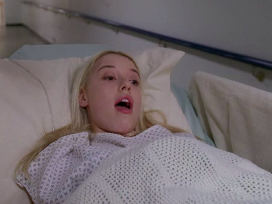 Katie Bryce on Greys Anatomy in a hospital bed mostly covered with blanket