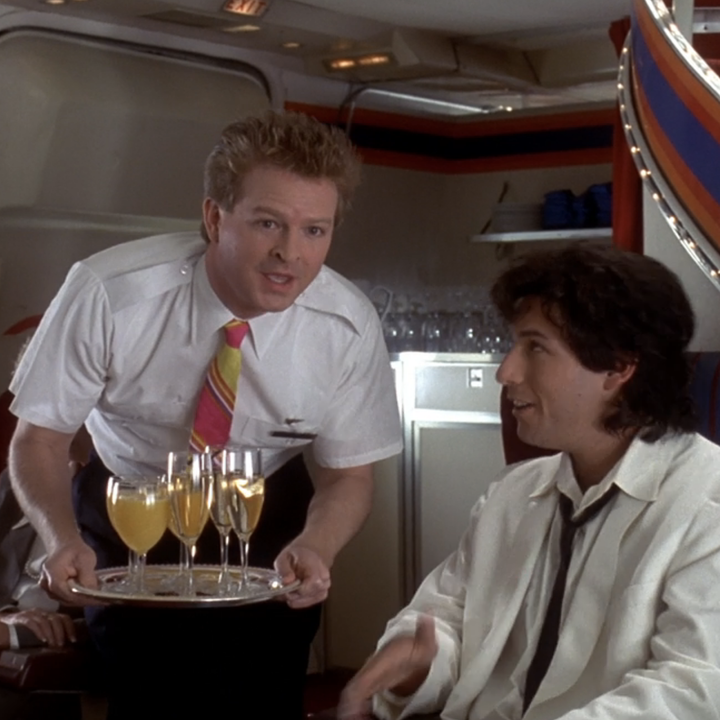 The airplane scenes in The Wedding Singer epitomize everything we like about airplane scenes. Not only do we get the random pairing of people, but we also see flight attendant high jinks and a grandiose declaration of love. Robbie (Adam Sandler) tells the other first-class members, including Billy Idol, played by the real-life Billy Idol, the story of his love for Julia (Drew Barrymore). While sitting in economy, Julia's awful fiancé hits on one of the flight attendants; the flight attendant then tells the first-class passengers, leading Robbie to realize that Julia is also on the plane! The same plane! Idol announces that 