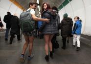 Passengers, not wearing pants, walk through a subway train transfer tunnel during the "No Pants Subway Ride" in Prague January 12, 2014. The event is an annual flash mob and occurs in different cities around the world in January, according to its organisers. REUTERS/David W Cerny (CZECH REPUBLIC - Tags: TRANSPORT SOCIETY ANNIVERSARY)