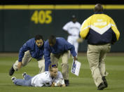 A fan who ran on the field apparently with the intent of scattering the remains of his mother on the field is subdued by security guards during the game between the Seattle Mariners and the New York Yankees on August 31, 2005 at Safeco Field in Seattle, Washington. The Yankees defeated the Mariners 2-0. (Photo by Otto Greule Jr/Getty Images)