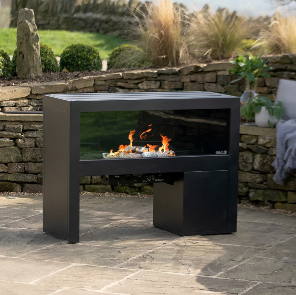7. Zone your space with an outdoor fireplace