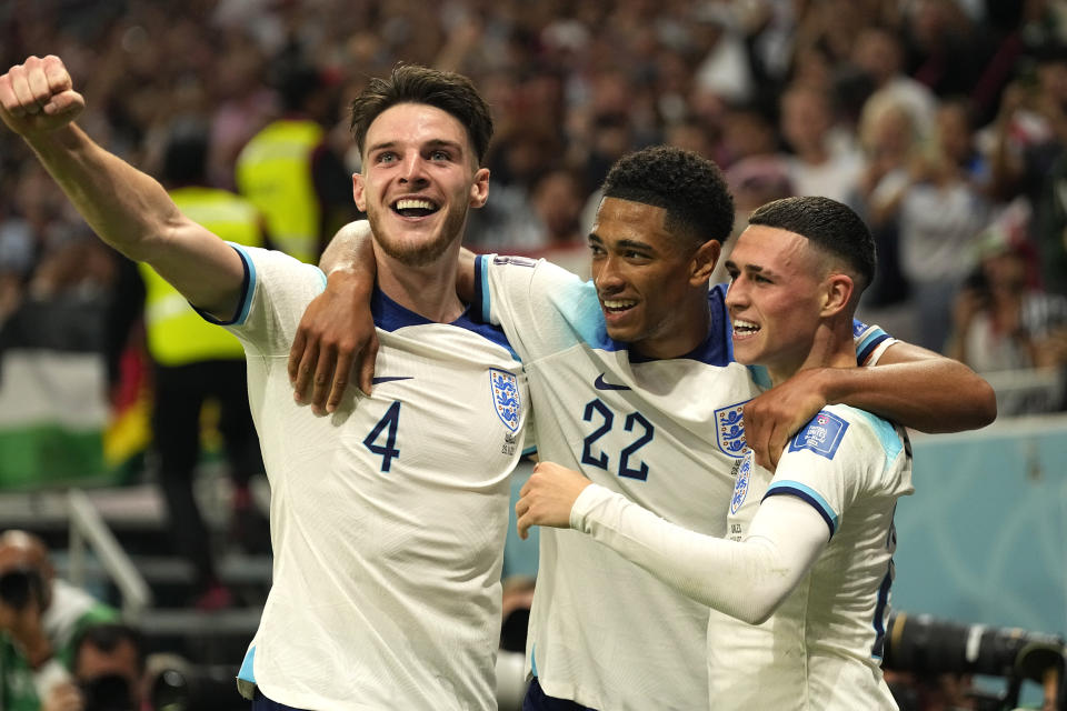 England's Phil Foden, right, celebrates with teammates after scoring his side's second goal during the World Cup group B soccer match between England and Wales, at the Ahmad Bin Ali Stadium in Al Rayyan, Qatar, Tuesday, Nov. 29, 2022. (AP Photo/Pavel Golovkin)