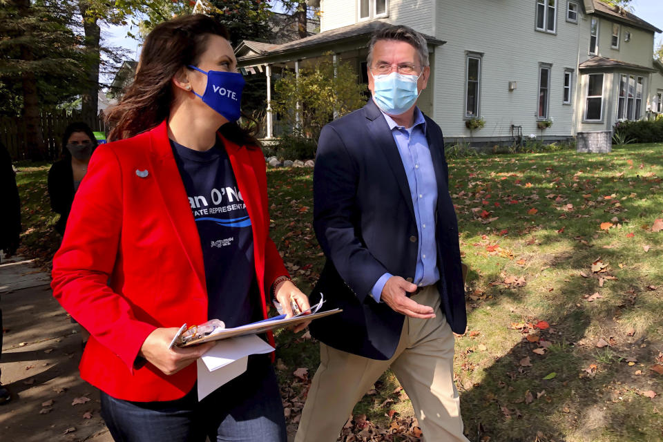 Michigan Gov. Gretchen Whitmer campaigns with Dan O'Neil, a Democratic candidate for the Michigan House in Traverse City, Mich., Friday, Oct. 9, 2020. Whitmer visited the area the day after police announced a foiled plot to kidnap the governor. (AP Photo/John Flesher)