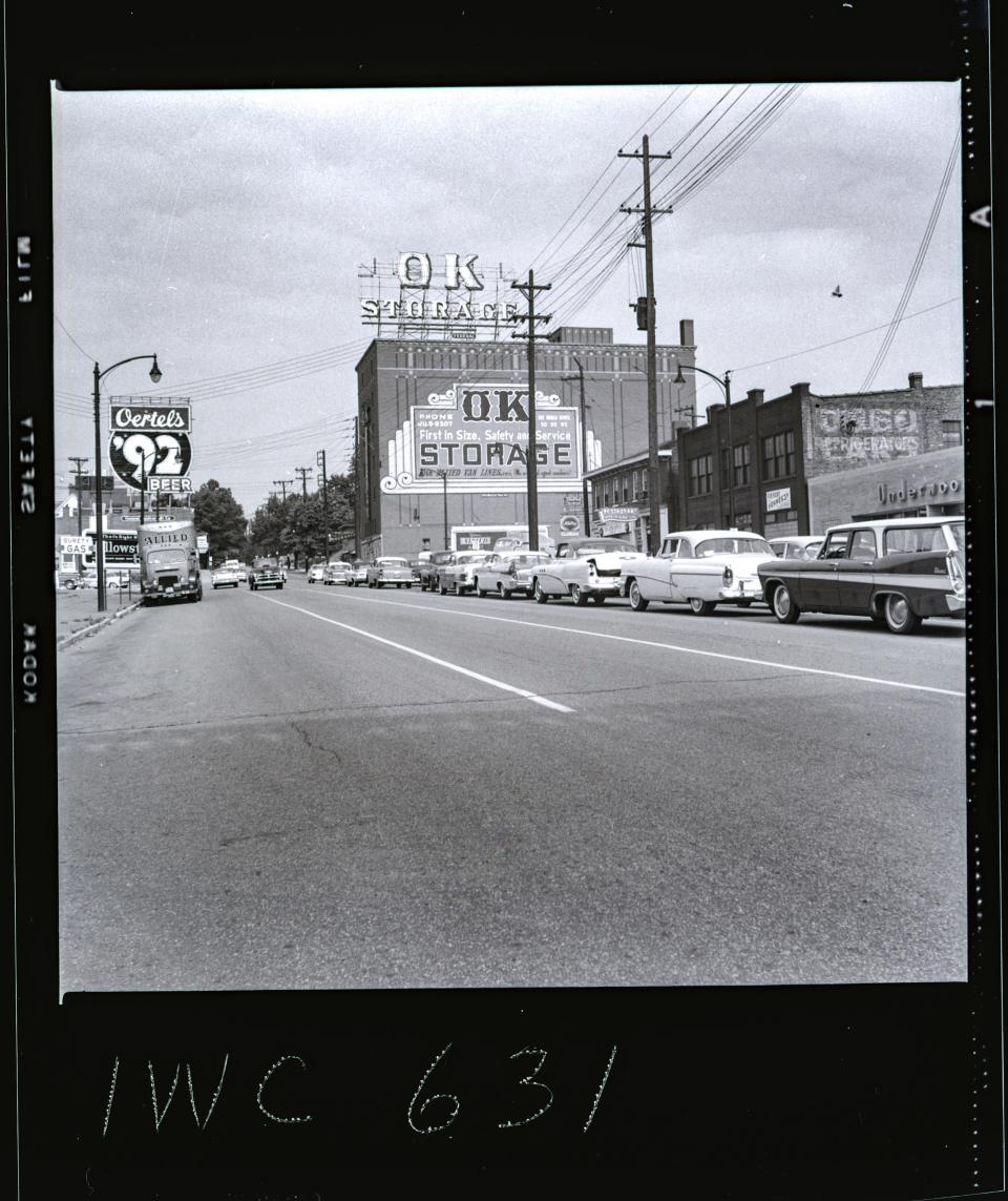 A view of East Broadway and the O.K. Moving and Storage Company. This sign is currently covered by a Louisville Hometown Heroes banner.