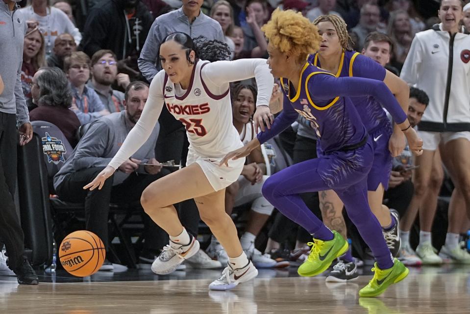 Virginia Tech's Kayana Traylor gets past LSU's Jasmine Carson during the first half of an NCAA Women's Final Four semifinals basketball game Friday, March 31, 2023, in Dallas. (AP Photo/Darron Cummings)