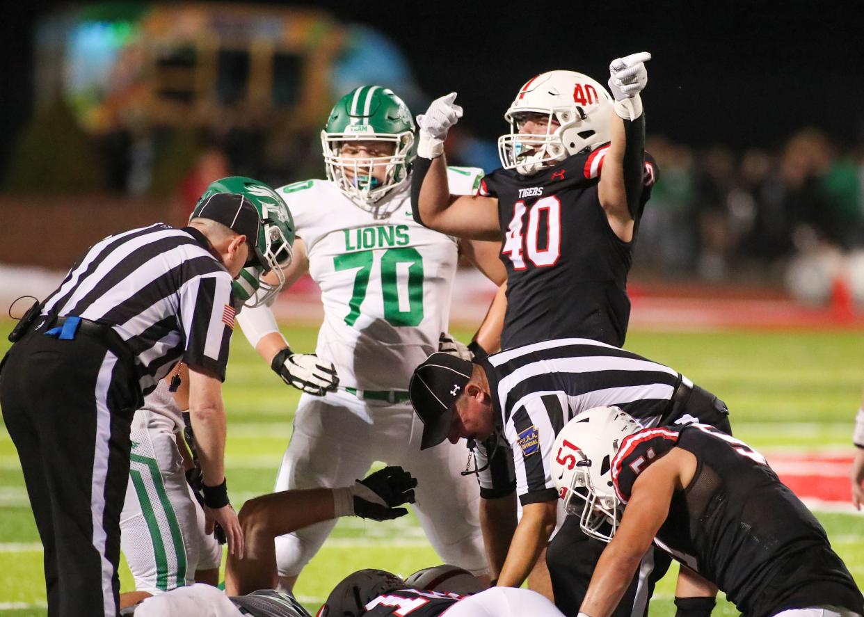 Moon's Nicholas Clemens (40) celebrates a turnover during the first half against South Fayette Friday night at Tiger Stadium in Moon Township, PA.