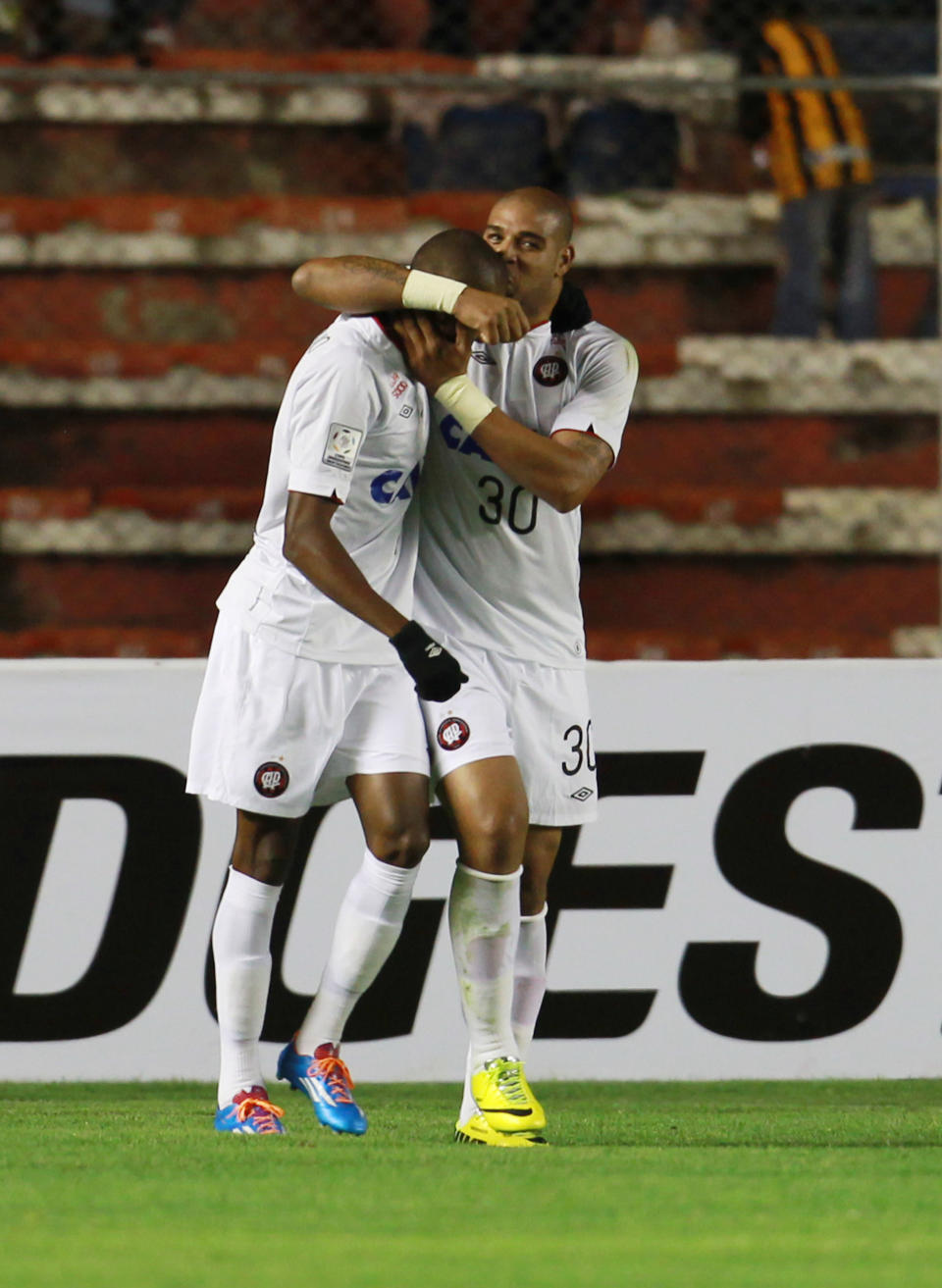 Adriano of Atletico Paranaense, right, celebrates with teammate Marcelo Cirino after scoring against Bolivia's The Strongest at a Copa Libertadores soccer match in La Paz, Bolivia, Tuesday, April 8, 2014. (AP Photo/Juan Karita)