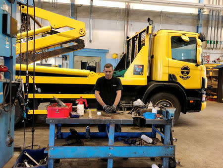 Muhsen Mousa, a 42-year-old Syrian refugee, who is employed as a mechanic at Scania's Swedish retail business works to repair a truck at the companyÕs workshop on the outskirts of Stockholm, Sweden July 6, 2018. Picture taken July 6, 2018. REUTERS/Esha Vaish