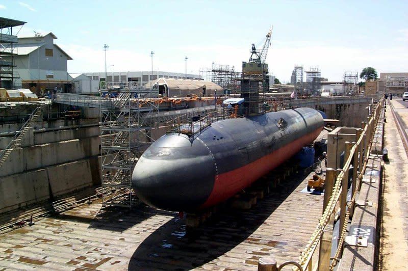 USS Greeneville sits in Dry Dock No. 1 at the Pearl Harbor Naval Shipyard and Intermediate Maintenance Facility for damage assessment and repairs following a February 9, 2001, collision at sea with the Japanese fishing vessel Ehime Maru. File Photo courtesy the U.S. Navy