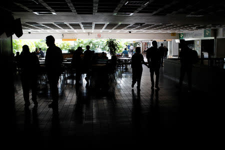 People walk at a shopping mall during a blackout in Caracas, Venezuela March 7, 2019. REUTERS/Manaure Quintero