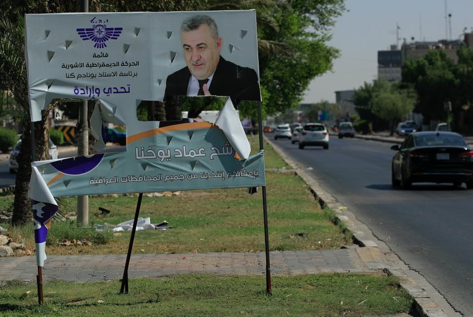 An electoral poster for the upcoming parliamentary elections is seen torn in Baghdad, Iraq, Sunday, Sept. 26, 2021. (AP Photo/Hadi Mizban)