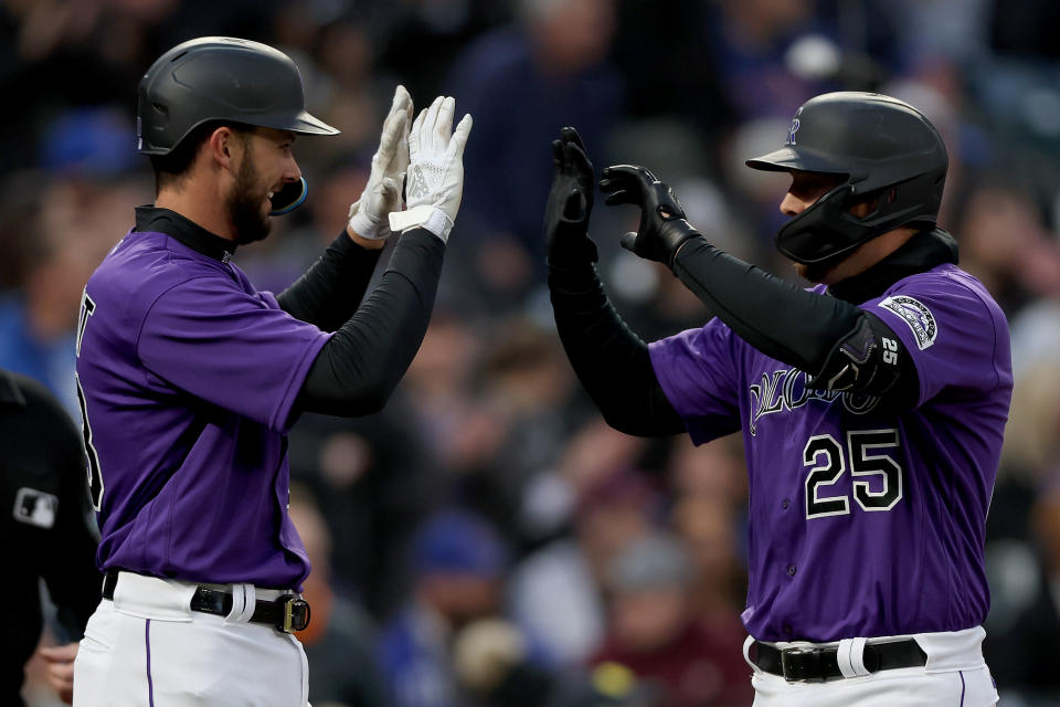 DENVER, COLORADO - APRIL 16: C.J. Cron #25 of the Colorado Rockies celebrates with Kris Bryant 23 after hitting a 3 RBI home run against the Chicago Cubs in the third inning at Coors Field on April 16, 2022 in Denver, Colorado.  (Photo by Matthew Stockman/Getty Images)
