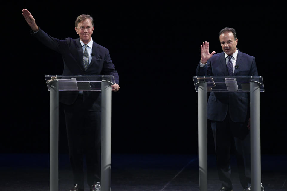 FILE - In this Thursday, July 12, 2018, file photo, Democratic gubernatorial candidates Ned Lamont, left, and Bridgeport Mayor Joe Ganim wave at the end of debate in New Haven, Conn. Lamont is the party's endorsed candidate, while Ganim petitioned his way onto the Aug. 14 ballot. Democrats and Republicans go to the polls in the most crowded primary field in Connecticut's recent history, on Tuesday, Aug. 14, 2018. (AP Photo/Jessica Hill, File)