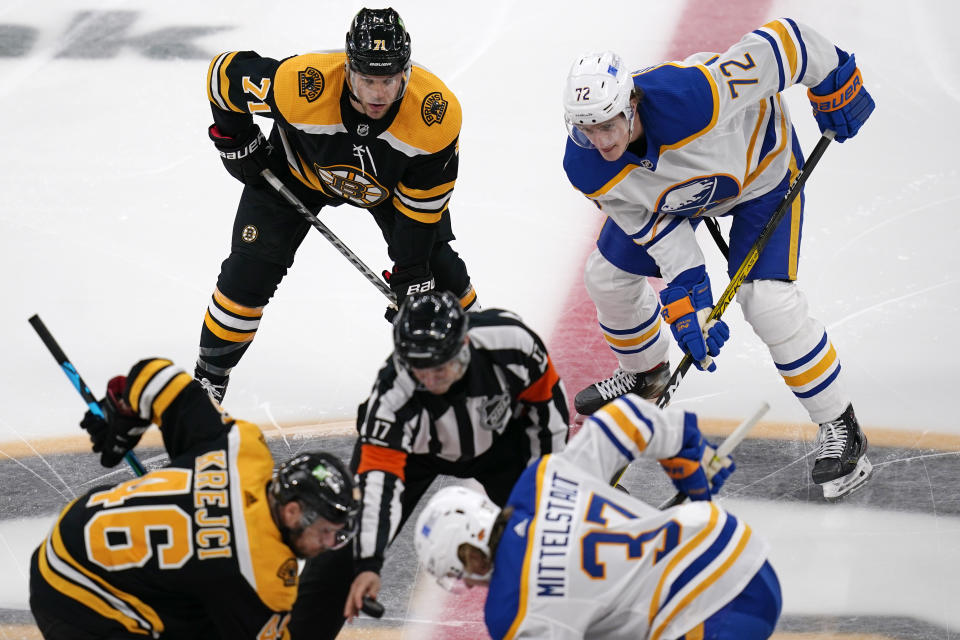 Boston Bruins left wing Taylor Hall (71) waits next to Buffalo Sabres right wing Tage Thompson (72) at the opening faceoff of an NHL hockey game Tuesday, April 13, 2021, in Boston. (AP Photo/Charles Krupa)