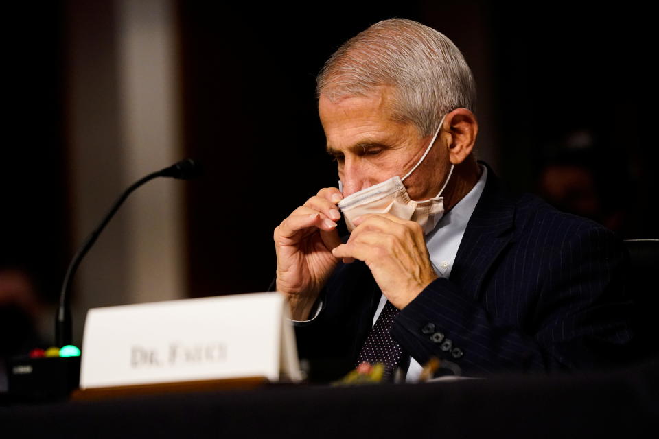 Dr. Anthony Fauci adjusts his mask during a hearing on 