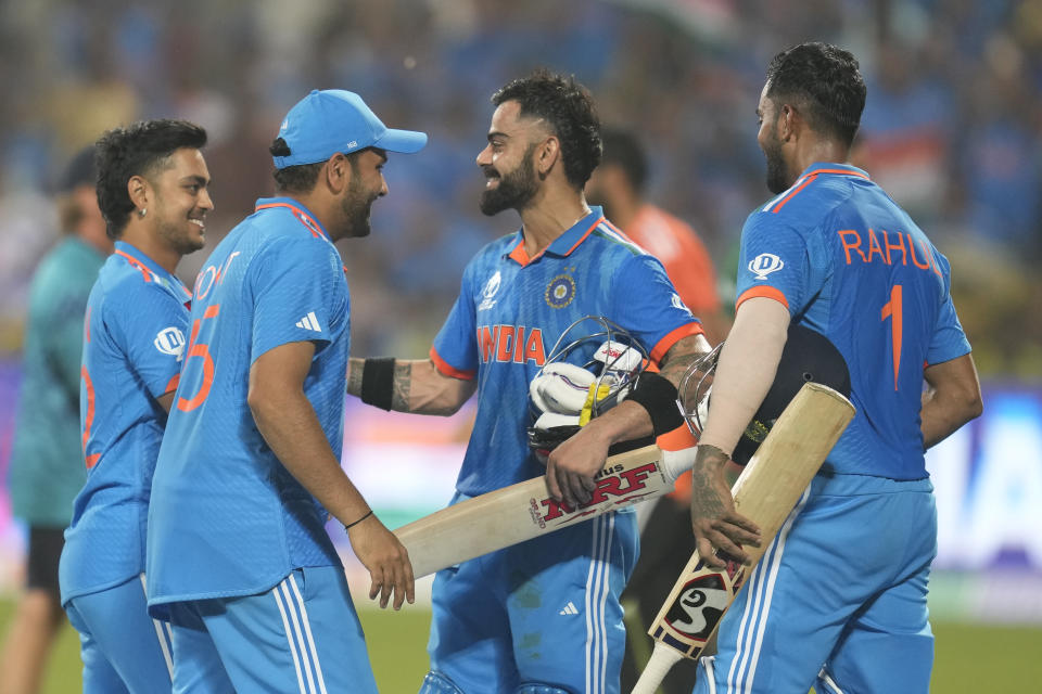 India's Virat Kohli, second right, is greeted by his teammates after he scored his century and won the ICC Men's Cricket World Cup match against Bangladesh in Pune, India, Thursday, Oct. 19, 2023. (AP Photo/ Rafiq Maqbool)