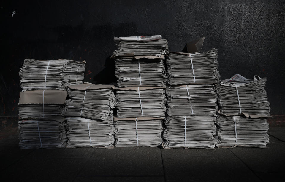 A stack of newspapers near Bixton Station, as the spread of the coronavirus disease (COVID-19) continues, London, Britain, April 3, 2020. REUTERS/Hannah McKay - RC24XF9JK5Z3