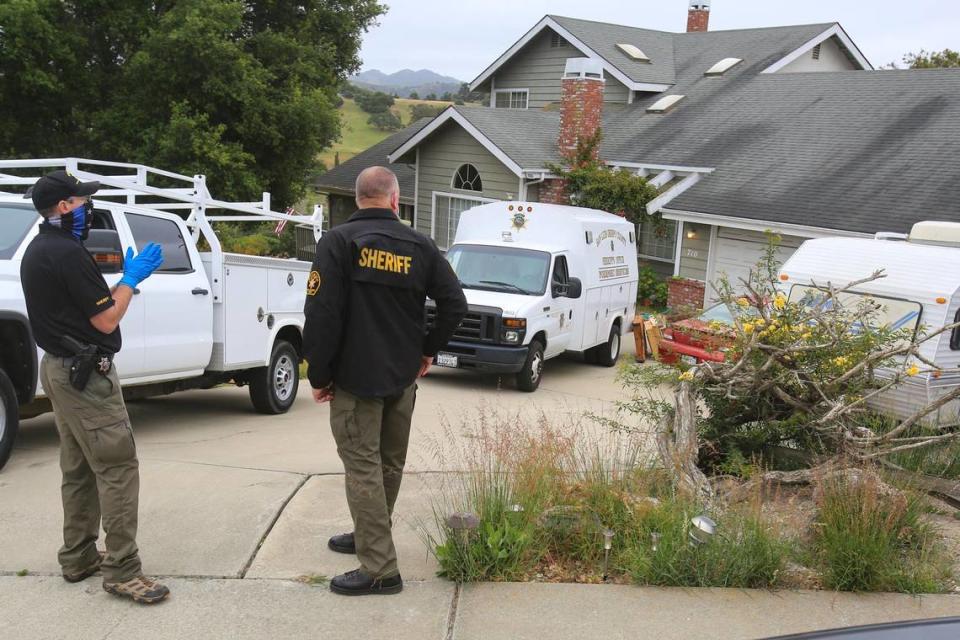 Investigators with the San Luis Obispo County Sheriff’s Office stand outside the Arroyo Grande home of Ruben Flores on Tuesday, April 13, 2021. Ruben Flores and his son, Paul Flores, were arrested in the disappearance of Cal Poly student Kristin Smart in 1996. Investigators were executing a new search warrant at the home.