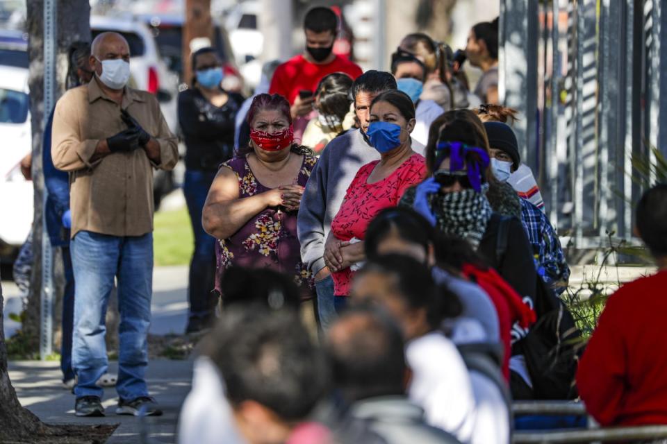 Parents line up for meal bags at Hudnall Elementary School