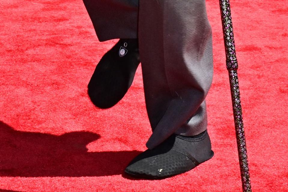 The iconic actor appeared to wear thick, slip-on sock shoes to the event. AFP via Getty Images