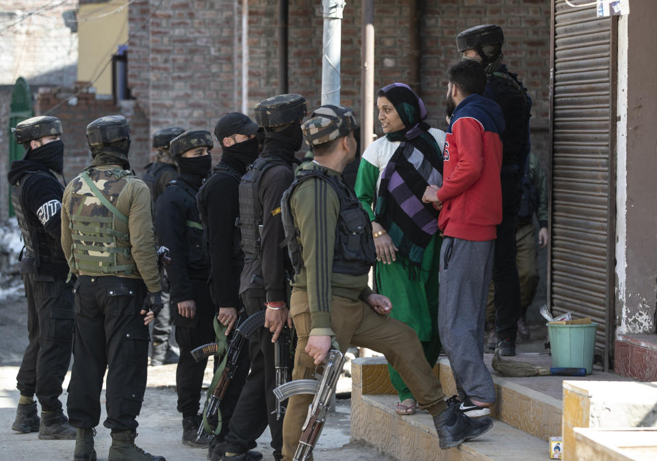 Members of Special Operations Group (SOG) of Jammu and Kashmir police question civilians near the site of a shootout in Srinagar, Indian controlled Kashmir, Friday, Feb. 19, 2021. Anti-India rebels in Indian-controlled Kashmir killed two police officers in an attack Friday in the disputed region’s main city, officials said. Elsewhere in the Himalayan region, three suspected rebels and a policeman were killed in two gunbattles. (AP Photo/Mukhtar Khan)