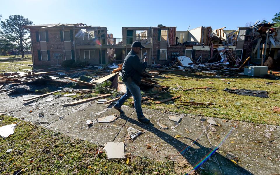 Eutaw Police Chief Tommy Johnson surveys the damage to one of the buildings in the Sagewood Apartments complex in Eutaw, Ala., on Wednesday, the day after a small tornado hit the town located in Greene County. No injuries were reported from the storm.