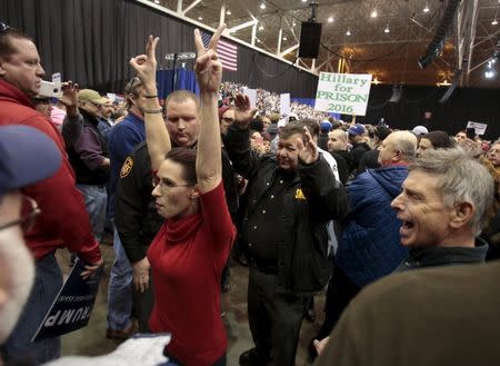 An anti-Trump protester is escorted out of the arena during a campaign rally for Republican U.S. presidential candidate Donald Trump in Cleveland, Ohio, March 12, 2016. REUTERS/Rebecca Cook