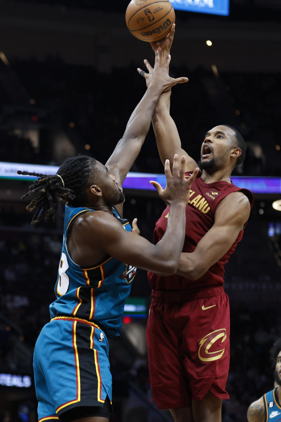 Cleveland Cavaliers forward Evan Mobley, right, shoots against Detroit Pistons center Isaiah Stewart during the second half of an NBA basketball game, Wednesday, Feb. 8, 2023, in Cleveland. (AP Photo/Ron Schwane)