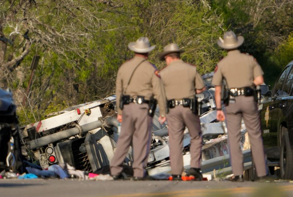 State troopers look at a vehicle that was involved in the fatal crash Friday.